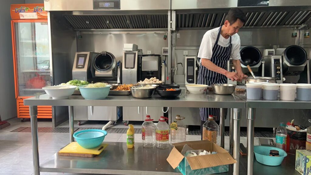 Customers use cooking machines to prepare dishes